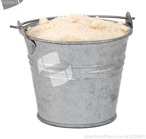 Image of Golden caster sugar in a miniature metal bucket