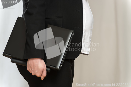 Image of Pregnant business woman with laptop