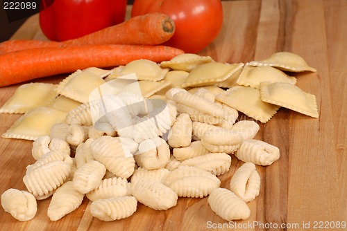 Image of Gnocchi and ravioli with vegetables in background