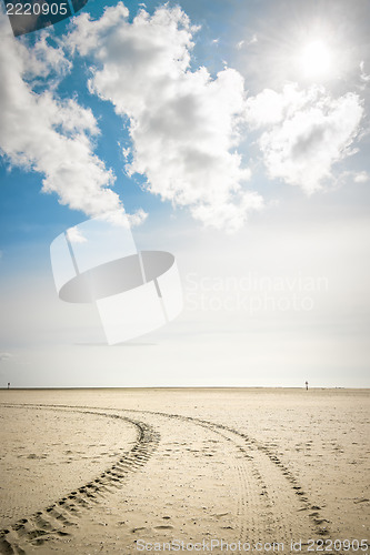 Image of Tire tracks in sand with backlight