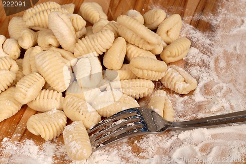 Image of Freshly made potato gnocchi on a floured cutting board