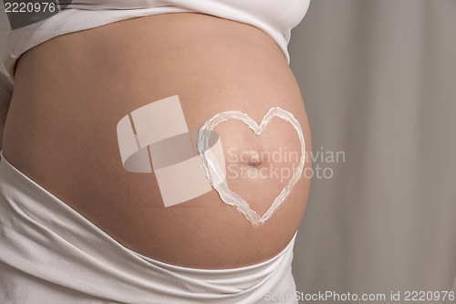 Image of cream heart on baby bump