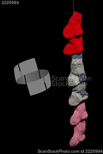 Image of Line of baby socks on black