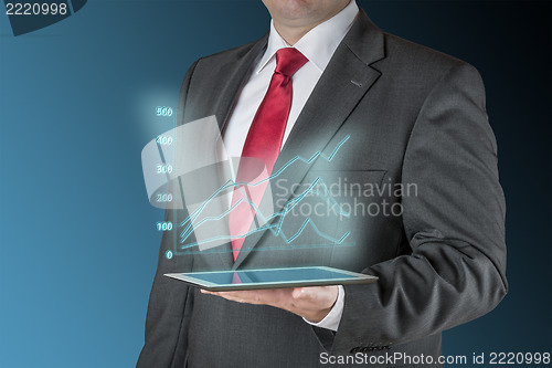 Image of Business man with tablet und stock chart