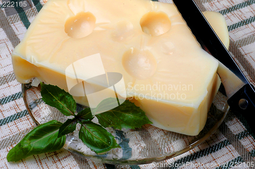 Image of swiss cheese on plate with knife