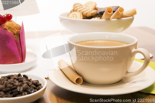 Image of Cup of coffee with beans and muffin