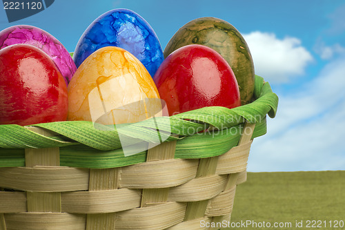 Image of Colored easter egg basket with blue sky