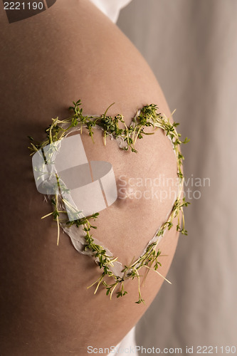 Image of Close Up baby bump with cress heart