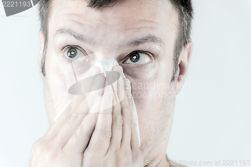 Image of Man with flu is sneezing