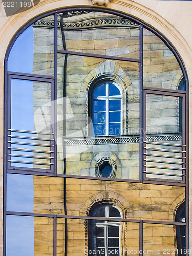 Image of Mirroring of a old house in window