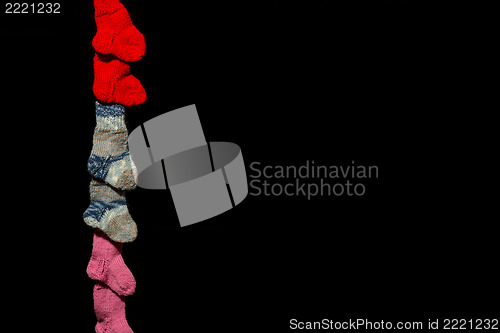 Image of Three pairs of baby socks on black background