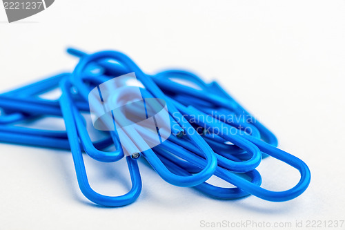 Image of Blue paperclips on white background