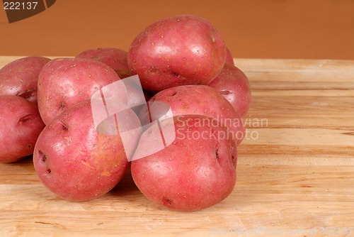 Image of Several red potatoes piled on a cutting board