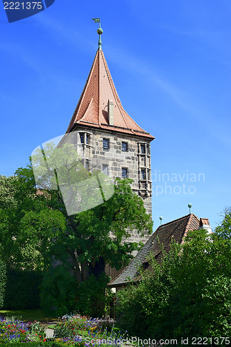 Image of Tower of Nuremberg Castle with tree and flowers