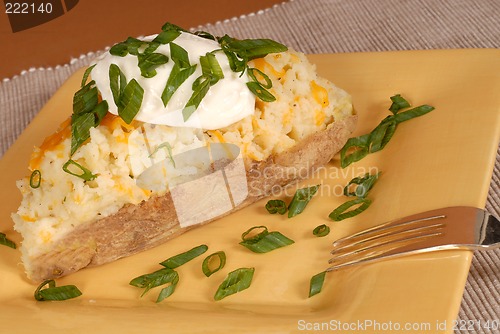 Image of Twice baked potato with scallions, cheese and sour cream