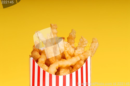 Image of Box of french fries with yellow background