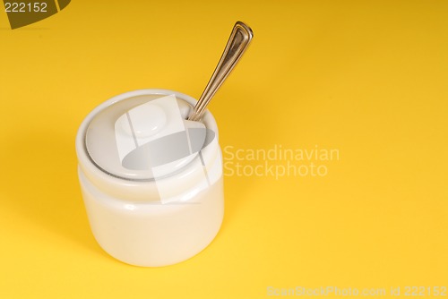 Image of White sugar bowl on a yellow background