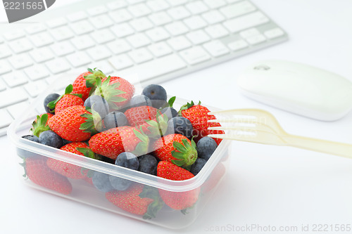 Image of Health lunch with strawberry and blueberry mix in office