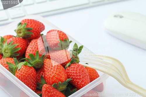 Image of Healthy lunch with strawberry and blueberry mix in office