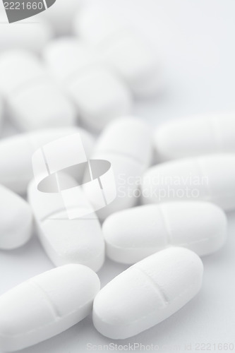 Image of White pills on white background