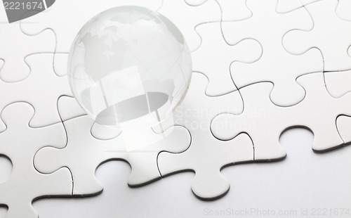 Image of Glass globe ball with puzzle background