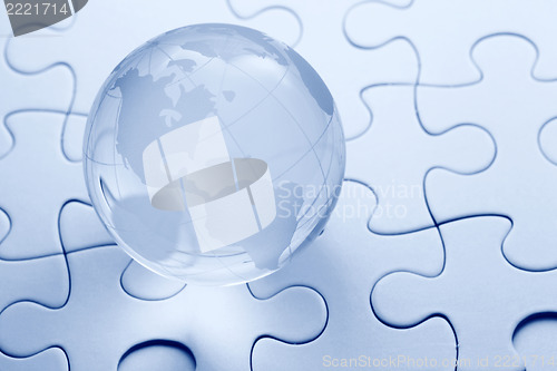 Image of Glass globe ball with puzzle background