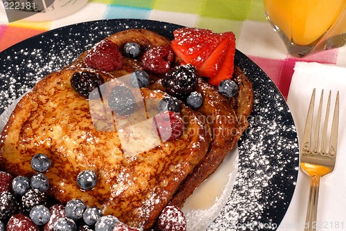 Image of French toast with fruit and maple syrup closeup