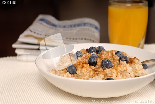 Image of Bowl of oatmeal with brown sugar, blueberries, orange juice