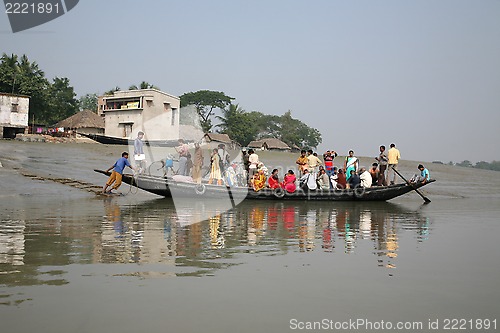 Image of Wooden boat crosses the Ganges River in Gosaba, West Bengal, India