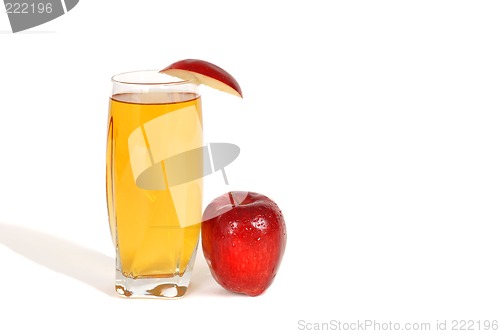 Image of Glass of apple juice with an apple wedge and apple next to glass