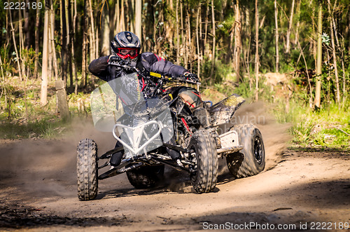 Image of ATV racer takes a turn during a race. 