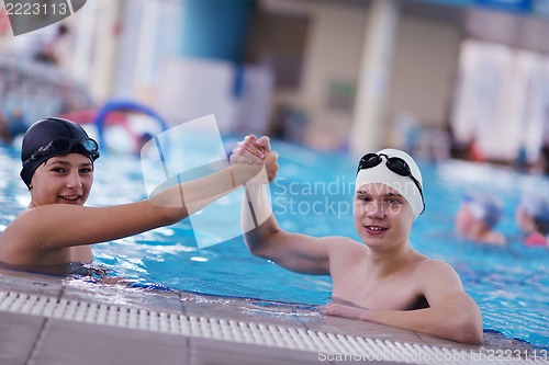 Image of happy teen group  at swimming pool