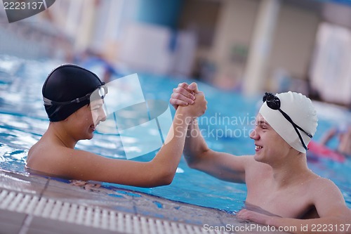 Image of happy teen group  at swimming pool
