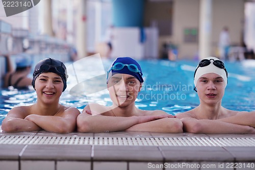 Image of happy teen group  at swimming pool