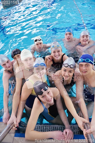 Image of happy teen group  at swimming pool