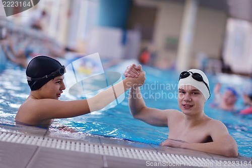 Image of happy teen group  at swimming pool