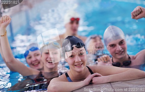 Image of happy teen group  at swimming pool