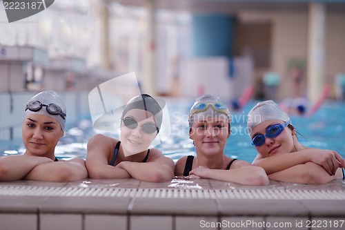 Image of happy teen group  at swimming pool