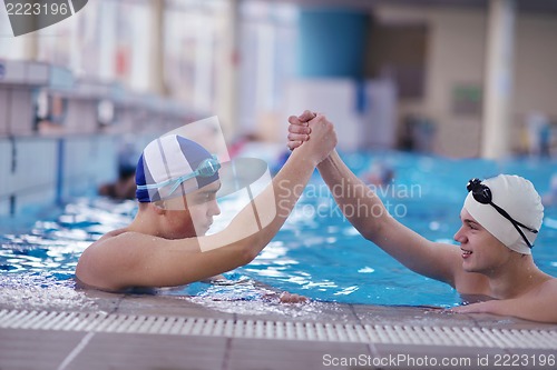 Image of happy teen group  at swimming pool