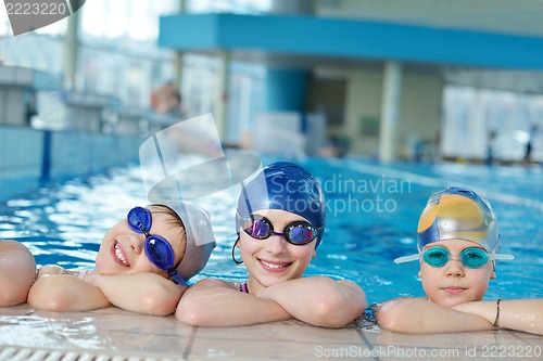 Image of happy children group  at swimming pool