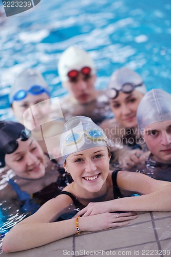Image of happy teen group  at swimming pool
