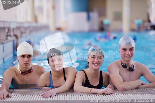 Image of happy teen group  at swimming pool