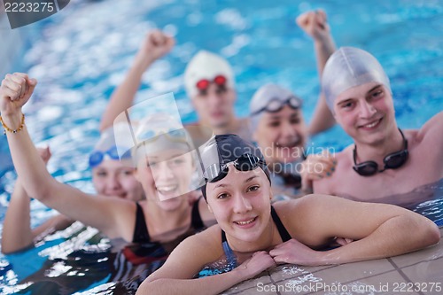 Image of happy teen group  at swimming pool