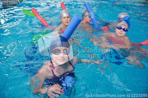 Image of happy children group  at swimming pool