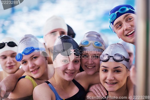 Image of happy teen group  at swimming pool