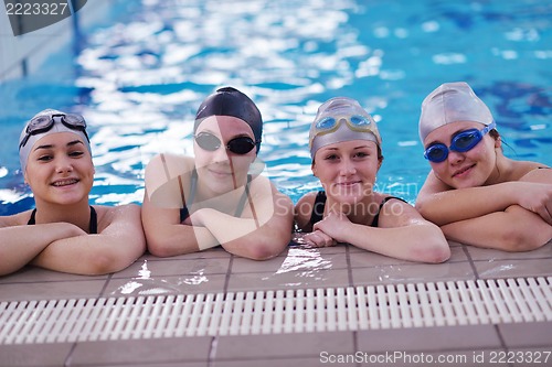 Image of happy teen group  at swimming pool