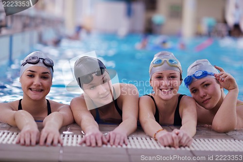 Image of happy teen group  at swimming pool