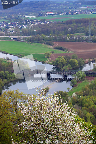 Image of Bridge crossing a river at the green valley and farmland