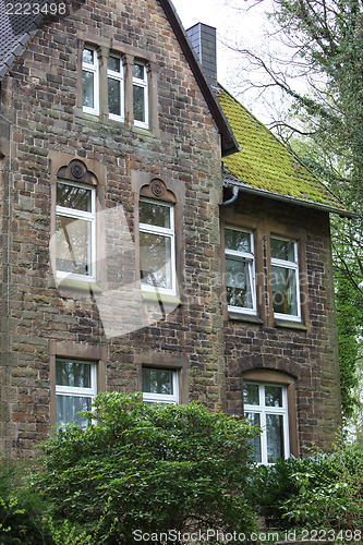 Image of Old stone house with a mossy roof