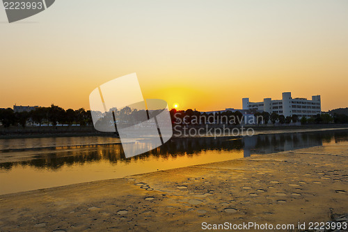 Image of Sunset along river at factories
